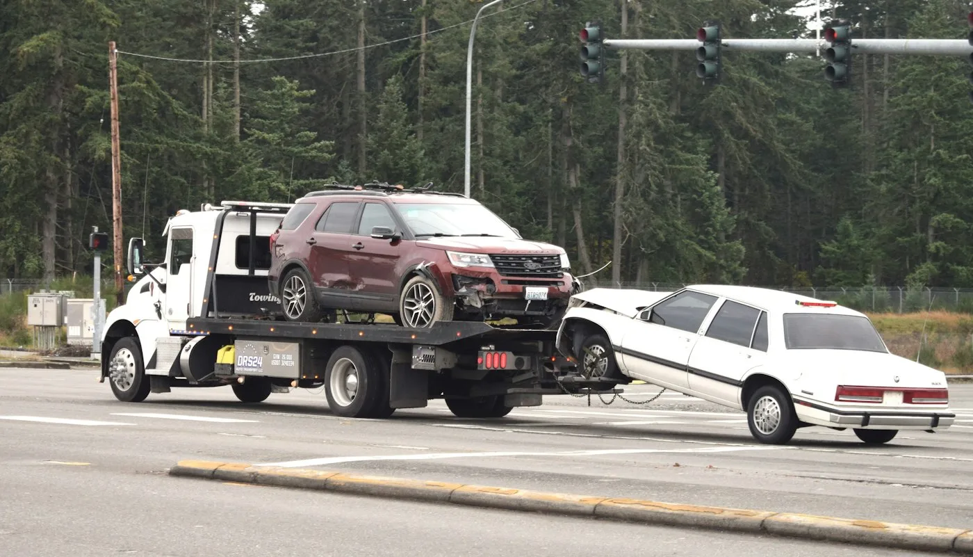 Car recovery truck carrying a vehicle in Sharjah